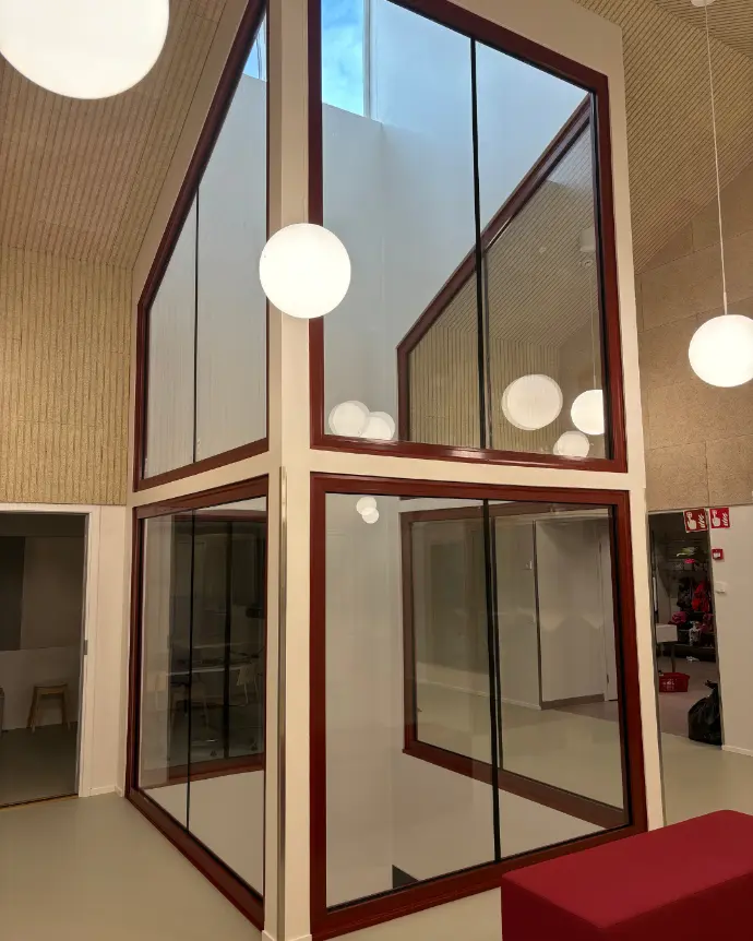 Lasiseinä sisätiloissa, jossa näkyy modernia arkkitehtuuria.